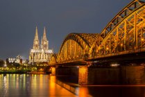 Germany, North Rhine-Westphalia, Cologne, lighted Cologne cathredral and Hohenzollern Bridge by night — Stock Photo