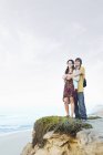 Happy couple standing at the coast — Stock Photo