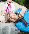 Portrait of senior man lying with head on his wife's lap — Stock Photo