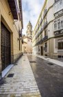 Spain, Andalusia, Malaga, Old town, alley and Cathedral of Malaga in the background — Stock Photo