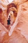 USA, Utah, Escalante, Peek-A-Boo and Spooky Slot Canyons, young woman looking at the beauty of nature — Stock Photo