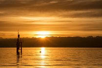 Germania, Veduta del faro sul Lago di Costanza al tramonto dorato — Foto stock