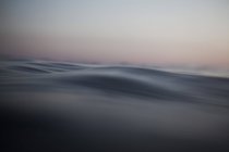Sea wave closeup view at calm sunset — Stock Photo
