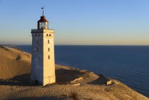 Denmark, View of Rubjerg Knude Lighthouse at North Sea against water — Stock Photo