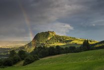 Germany, Baden Wuerttemberg, Constance, View of Hegau green mountain landscape with rainbow — Stock Photo