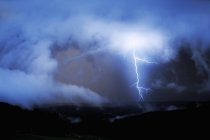 Scenic view of striking lightning in clouded sky while thunderstorm — Stock Photo