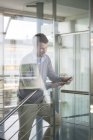 Mid adullt man using digital tablet — Stock Photo