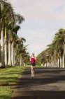 USA, Hawaii, Woman jogging on road — Stock Photo