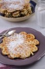Close-up of heart-shaped waffles with icing sugar on plate with cutlery — Stock Photo