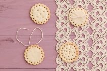 Butter cookies with peekaboo design on crochet tablecloth — Stock Photo