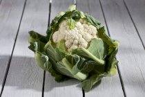 Fresh Cauliflower on grey wooden table — Stock Photo