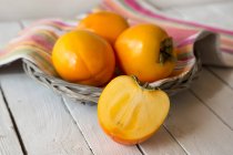 Kaki fruits and sliced Kaki fruit — Stock Photo