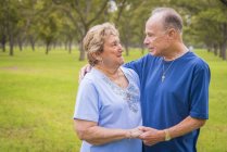 Portrait of senior couple looking at ech other outdors — Stock Photo