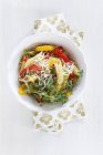 Bowl of pepper pasta with parmesan and thyme on wooden table, close up — Stock Photo