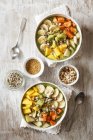 Smoothie bowls with mango, papaya, kiwi, banana, pear, lineseeds, sunflower-seeds and nuts — Stock Photo