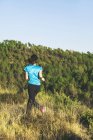Jovem jogger feminino em movimento na frente da floresta — Fotografia de Stock