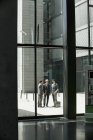 Trois hommes d'affaires caucasiens devant un immeuble de bureaux — Photo de stock