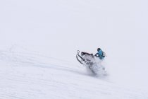 Canada, Whistler, Man snowmobiling on the mountain — Stock Photo