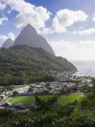 Caribe, Santa Lucía, Soufriere, Gros Piton y Petit Piton, vista de la ciudad en la costa y la colina en el fondo - foto de stock