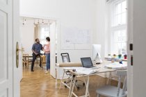 Two creative professionals talking in office — Stock Photo
