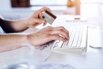 Homme effectuant un paiement en ligne avec carte de crédit — Photo de stock