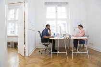 Two creative professionals working in office — Stock Photo