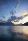 View of lake and mountain on background at sunset — Stock Photo