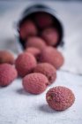 Upturned Bucket and fresh lychees — Stock Photo