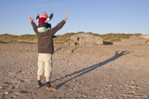 Denmark, Blavand, little girl and father playing on the beach — Stock Photo