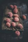 Fresh Lychees on wooden board on dark wood — Stock Photo