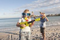 Children playing on sandy beach — Stock Photo