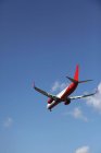 Passenger plane flying in blue sky — Stock Photo