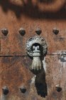 Close up of vintage hand knocker of door — Stock Photo