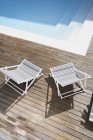 Deck chairs on wood at swimming pool — Stock Photo