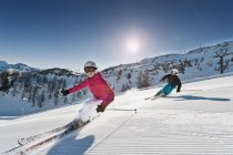 Austria, Salzburg, Young couple skiing on mountain — Stock Photo
