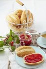Cornel cherry jam with bread rolls and coffee on table — Stock Photo
