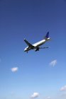 Passenger plane flying in blue sky — Stock Photo