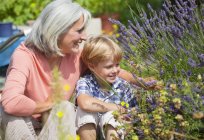Mature woman with boy in garden — Stock Photo