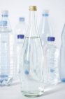 Glass bottles and plastic bottles, close up — Stock Photo