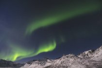 Aurora Boreal sobre montanhas nevadas — Fotografia de Stock