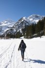 Austria, Woman hiking at Tannheim Alps in winter — Stock Photo