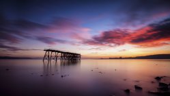 View of sea with pier at sunset, Scotland, United Kingdom — Stock Photo
