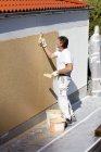 Mature  Man plastering house wall — Stock Photo
