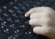 Human hand writing sex on keyboard, close up — Stock Photo