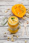 Pumpkin soup with croutons, garnished with parsley in jar — Stock Photo