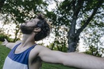 Handsome Man enjoying sunset in park — Stock Photo