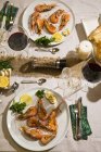 Argentine red shrimps on festive laid table — Stock Photo