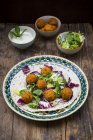 Falafel, wrap, salad, red and white cabbage, yogurt sauce with mint — Stock Photo