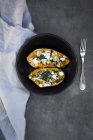 Filled sweet potato with spinach, red onion, couscous, feta and coriander — Stock Photo