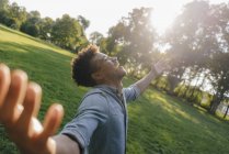 Young african american man enjoying sunset in park — Stock Photo